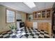 Kitchen with black and white checkerboard floors and wooden cabinets at 3695 Highway 140, Rydal, GA 30171
