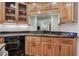 Cozy kitchen featuring custom cabinets, black granite countertops, and stainless steel dishwasher at 3695 Highway 140, Rydal, GA 30171