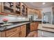 Elegant kitchen boasts granite counters, wood cabinets, and sleek appliances at 3695 Highway 140, Rydal, GA 30171