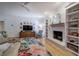Bright living room with a fireplace, built-in shelves and hardwood floors at 3695 Highway 140, Rydal, GA 30171
