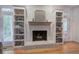 Cozy living room featuring a brick fireplace flanked by built-in bookshelves at 3695 Highway 140, Rydal, GA 30171