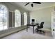 Bright office space with three large windows, custom shutters, desk, chair, and built in shelving at 3695 Highway 140, Rydal, GA 30171