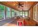 Inviting sunroom features a brick floor, wood ceiling, and views of the surrounding greenery at 3695 Highway 140, Rydal, GA 30171