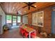 Inviting sunroom features a brick floor, wood ceiling, and views of the surrounding greenery at 3695 Highway 140, Rydal, GA 30171