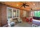 Sunroom features brick walls and flooring, lots of windows, and ample seating for outdoor relaxation at 3695 Highway 140, Rydal, GA 30171