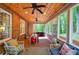 Charming sunroom boasts brick floors, a wood plank ceiling, and serene views of the lush backyard at 3695 Highway 140, Rydal, GA 30171
