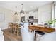 Modern kitchen with stainless appliances, pendant lights, breakfast bar, and white cabinetry at 200 Starr Cir, Stockbridge, GA 30281