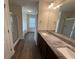Bathroom with double vanity, granite countertops, walk-in shower, and soaking tub at 2335 Hackamore Dr, Atlanta, GA 30349