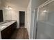 Bathroom featuring double vanity with granite countertops, tile flooring, and walk-in shower at 2335 Hackamore Dr, Atlanta, GA 30349