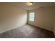 Simple bedroom design featuring gray carpet, minimal décor and a single window at 2335 Hackamore Dr, Atlanta, GA 30349