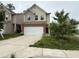 Two story home with two car garage and neutral siding, in need of yard maintenance at 2335 Hackamore Dr, Atlanta, GA 30349