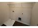 Empty laundry room features wood flooring, washer/dryer hookups and wire shelving at 2335 Hackamore Dr, Atlanta, GA 30349