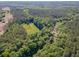 A stunning aerial view showcases the dense, green forest with a clearing ready for building a home at 2520 Hollonville, Brooks, GA 30205
