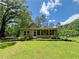 Well-maintained backyard featuring lush green lawn and a screened-in porch for outdoor enjoyment at 2520 Hollonville, Brooks, GA 30205