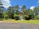 Large barn with covered parking surrounded by mature trees on a lush green lawn at 2520 Hollonville, Brooks, GA 30205