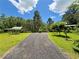 Wide angle view of a long driveway leading up to a home surrounded by trees at 2520 Hollonville, Brooks, GA 30205