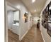 Well-lit hallway with wood floors, picture frames, and access to laundry and other rooms at 2520 Hollonville, Brooks, GA 30205