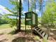 An elevated hunting stand overlooks a sprawling green field surrounded by lush trees at 2520 Hollonville, Brooks, GA 30205