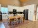 Bright and spacious kitchen with white cabinetry and a rustic wooden dining table set on a rug at 2520 Hollonville, Brooks, GA 30205