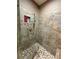 Close up of a tiled shower with stone pebble flooring and shower niche at 2520 Hollonville, Brooks, GA 30205