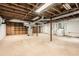 Unfinished basement area with exposed wood beams, utility lines, concrete floor, and washer and dryer hookups at 2648 Woodacres Ne Rd, Atlanta, GA 30345