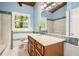 Well-lit bathroom with a white sink, a wooden vanity, and a large mirror that shows the shower and toilet area at 2648 Woodacres Ne Rd, Atlanta, GA 30345