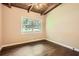 Cozy bedroom features beamed ceilings, hardwood floors, and natural lighting at 2648 Woodacres Ne Rd, Atlanta, GA 30345