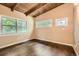 Comfortable bedroom showcasing gleaming hardwood floors and multiple windows at 2648 Woodacres Ne Rd, Atlanta, GA 30345