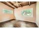 Bright bedroom featuring wood ceiling and floors, and lots of natural light from two windows at 2648 Woodacres Ne Rd, Atlanta, GA 30345