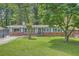 Charming single story home featuring a well manicured lawn, brick accents, and a classic exterior at 2648 Woodacres Ne Rd, Atlanta, GA 30345