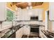 Bright kitchen with white cabinets, granite countertops, and stainless steel appliances at 2648 Woodacres Ne Rd, Atlanta, GA 30345