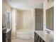 Bright bathroom featuring a bathtub, a shower, a window and a vanity with dark cabinets at 3013 Nicholas Dr, Villa Rica, GA 30180