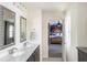 Bathroom with a double vanity, large mirrors, and a view into the bedroom at 3013 Nicholas Dr, Villa Rica, GA 30180