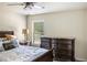 Cozy bedroom with neutral walls, a window with blinds, and a stylish bed at 3013 Nicholas Dr, Villa Rica, GA 30180