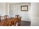 Dining room with wood floors and wainscoting featuring natural light and an ornate table set at 3013 Nicholas Dr, Villa Rica, GA 30180