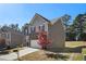 Side view of a two-story home with a stone front and neutral toned siding with mature landscaping at 3013 Nicholas Dr, Villa Rica, GA 30180