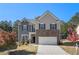 Two-story home featuring mixed material facade of stone, board and batten, and traditional siding at 3013 Nicholas Dr, Villa Rica, GA 30180
