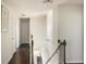 Bright hallway with hardwood floors, leading to the upper level of the house from the staircase at 3013 Nicholas Dr, Villa Rica, GA 30180