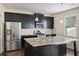 Kitchen featuring an island, granite counters, stainless steel appliances, and dark cabinets at 3013 Nicholas Dr, Villa Rica, GA 30180