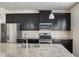 Kitchen showcasing granite counters, stainless steel appliances, and dark cabinetry at 3013 Nicholas Dr, Villa Rica, GA 30180