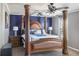 Spacious main bedroom with elegant furniture, a four-poster bed, and a view from the window at 3013 Nicholas Dr, Villa Rica, GA 30180
