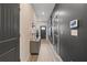 Hallway with modern decor, wood flooring, and dark gray accent wall at 344 Navigator Ln, Mcdonough, GA 30253