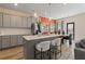 Open kitchen featuring a large island, modern appliances, and gray cabinetry at 344 Navigator Ln, Mcdonough, GA 30253