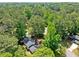 Lush aerial view showcases the home nestled among mature trees, creating a private, serene setting at 4058 Daron Ct, Ellenwood, GA 30294