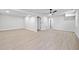Finished basement area featuring light wood-look floors, modern lighting, and fresh paint at 4058 Daron Ct, Ellenwood, GA 30294
