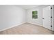 Bright bedroom featuring wood-look floors, white walls, a large window, and a closet at 4058 Daron Ct, Ellenwood, GA 30294