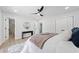 Bright bedroom features a modern ceiling fan, round mirror, and doorway to bathroom at 4058 Daron Ct, Ellenwood, GA 30294