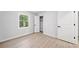 Clean bedroom with wood-look floors, fresh paint, a window, and closet at 4058 Daron Ct, Ellenwood, GA 30294