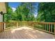 Spacious wooden deck offering outdoor space for relaxation and entertaining with a lush backyard view at 4058 Daron Ct, Ellenwood, GA 30294
