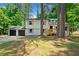 Inviting two-story home with a two-car garage, complemented by a well-manicured front lawn and mature trees at 4058 Daron Ct, Ellenwood, GA 30294